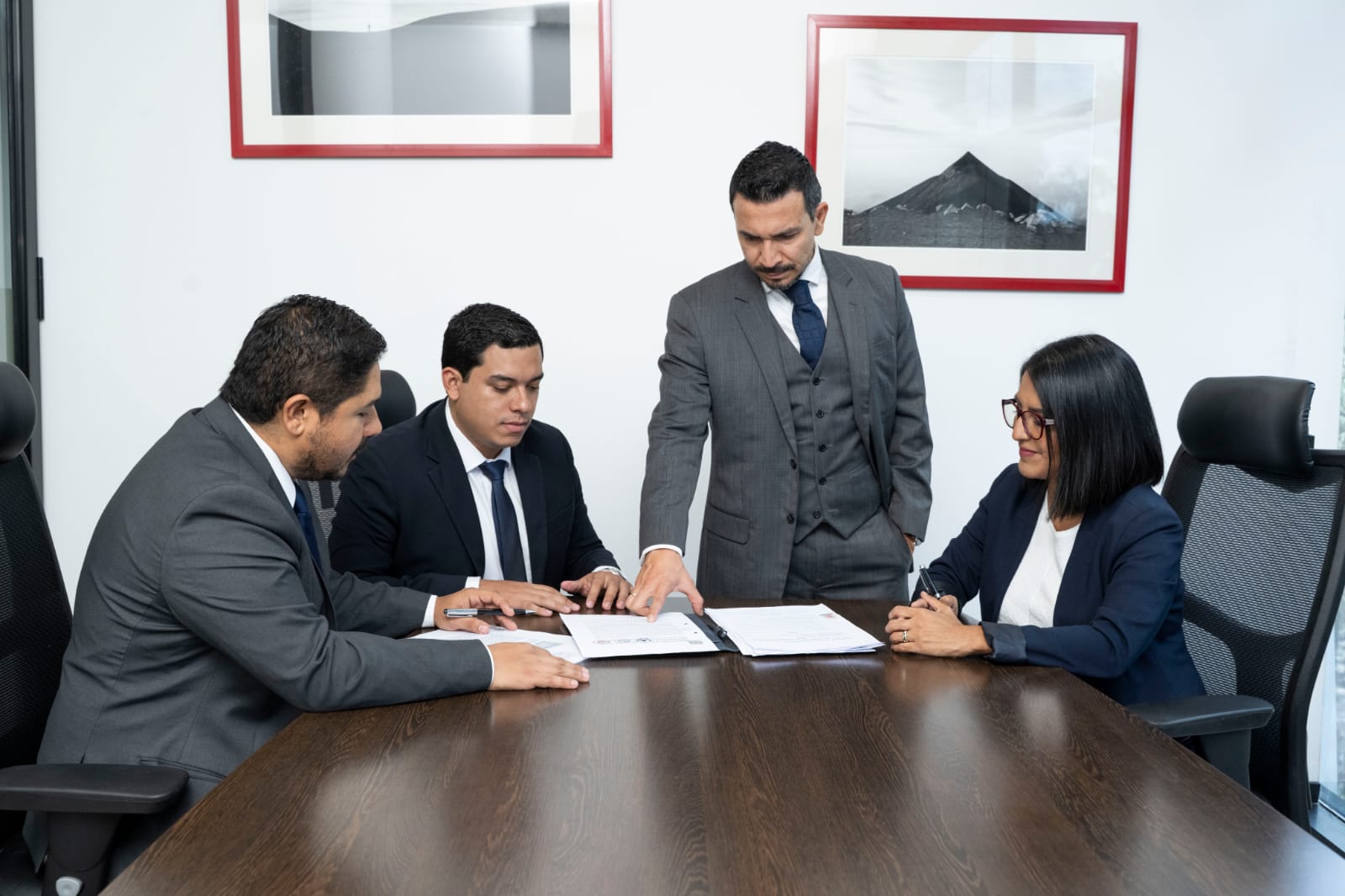 Equipo de Estratégica Legal revisando documentos en reunión de trabajo